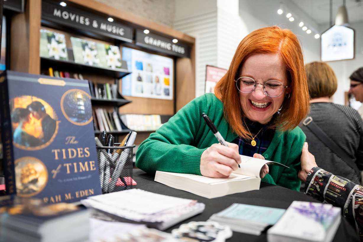 Author Sarah Eden signs South Jordan resident Ruby Cheesman’s book at a Deseret Book event at the City Creek Center in Salt Lake City on April 4.