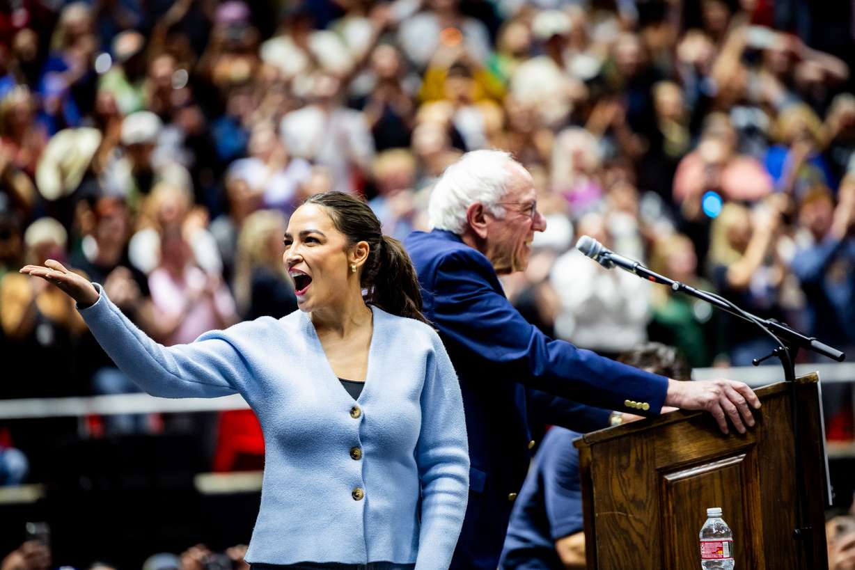 Rep. Alexandria Ocasio-Cortez, D-N.Y., blows a kiss to the audience as Sen. Bernie Sanders, I-Vt. speaks during a rally in Salt Lake City on Sunday.