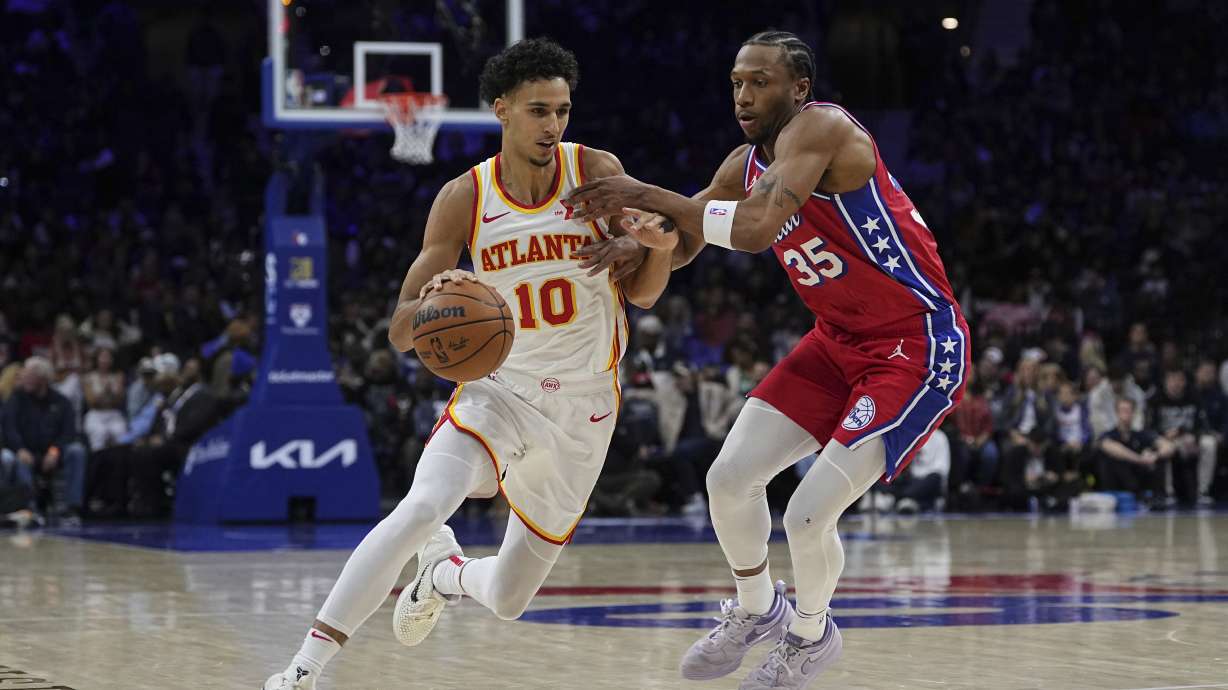 Atlanta Hawks' Zaccharie Risacher (10) tries to get past Philadelphia 76ers' Marcus Bagley (35) during the first half of an NBA basketball game Friday, April 11, 2025, in Philadelphia.