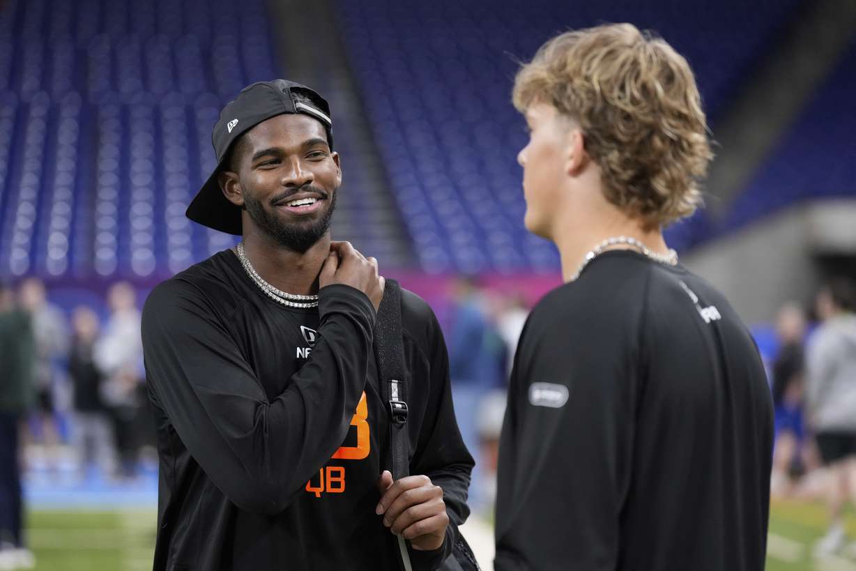 Colorado quarterback Shedeur Sanders talks to Mississippi quarterback Jaxson Dart at the NFL football scouting combine in Indianapolis, Saturday, March 1, 2025.