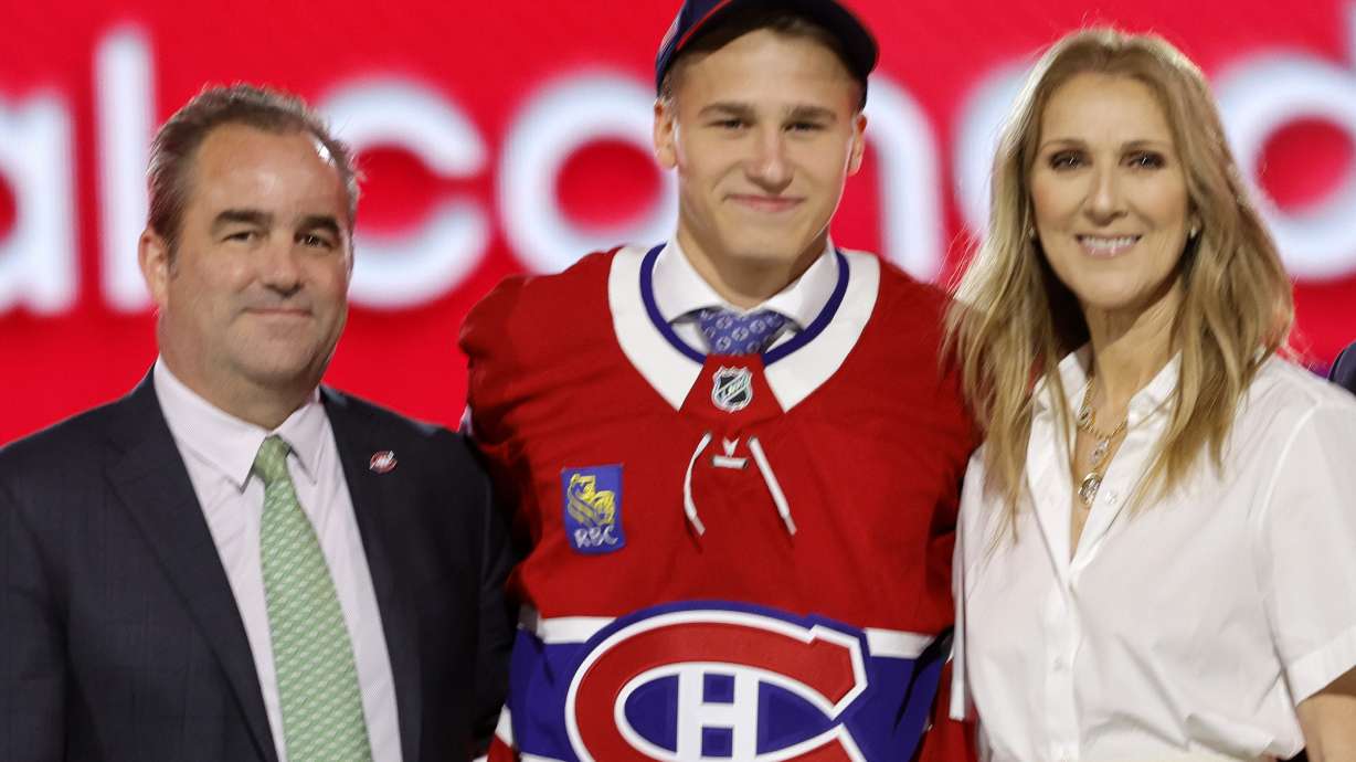 FILE - Ivan Demidov, center, poses, after being selected by the Montreal Canadiens during the first round of the NHL hockey draft Friday, June 28, 2024, in Las Vegas. The announcement was made by singer Celine Dion, right.