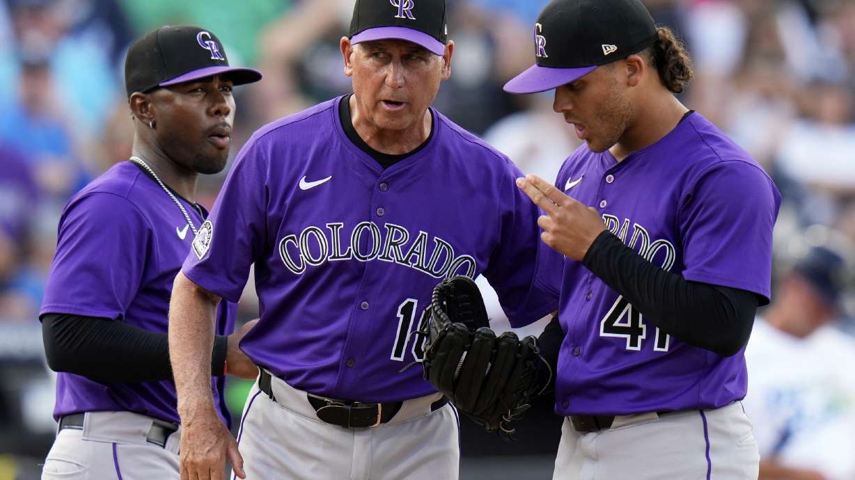 Colorado Rockies manager Bud Black (10) talks to pitcher Luis Peralta (41) after taking Antonio Senzatela out of the game against the Tampa Bay Rays during the fifth inning of a baseball game Saturday, March 29, 2025, in Tampa, Fla.