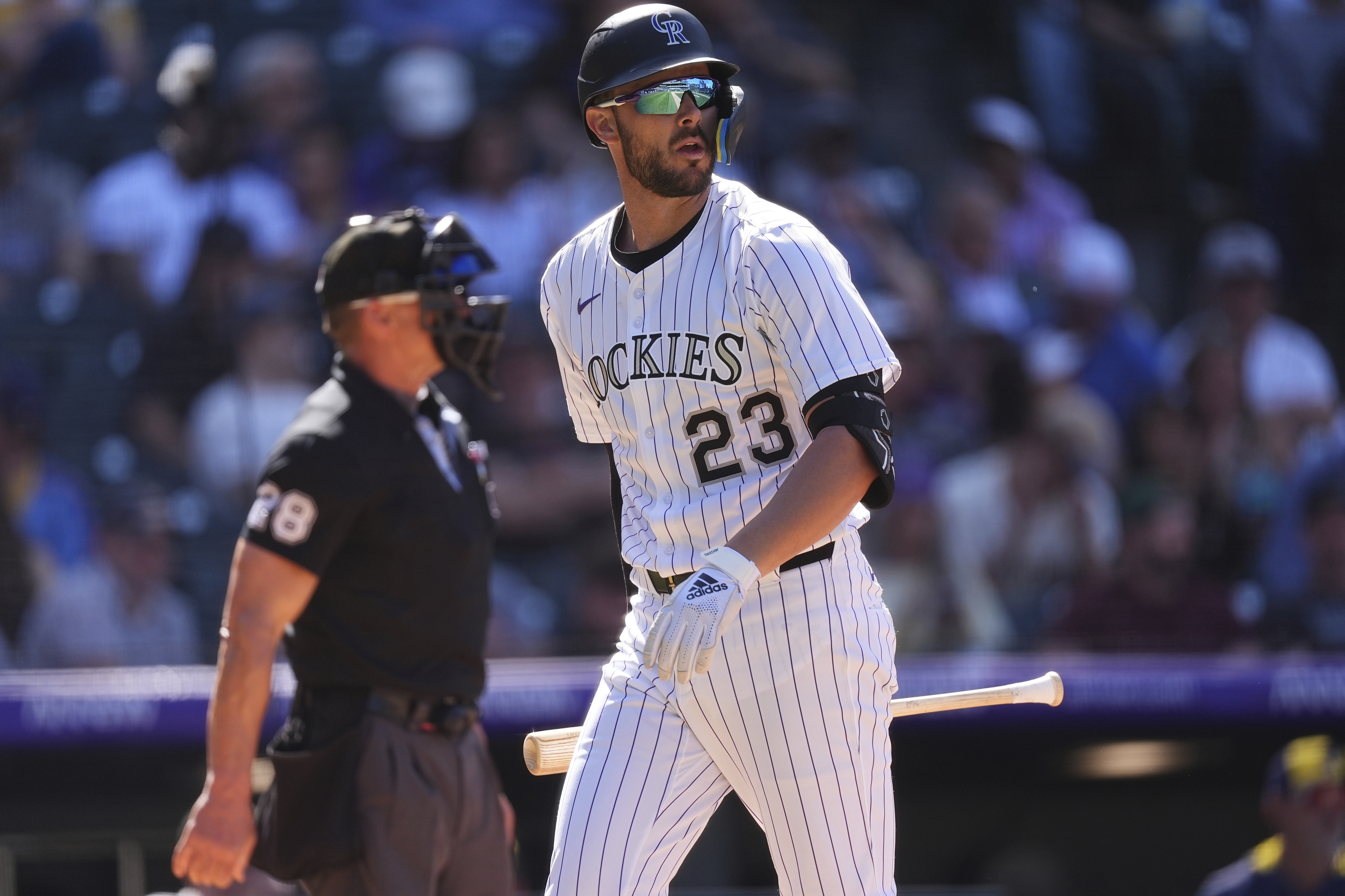 Colorado Rockies' Kris Bryant (23) heads to the dugout after striking out against Milwaukee Brewers relief pitcher Joel Payamps with the bases loaded in the eighth inning of a baseball game Thursday, April 10, 2025, in Denver.