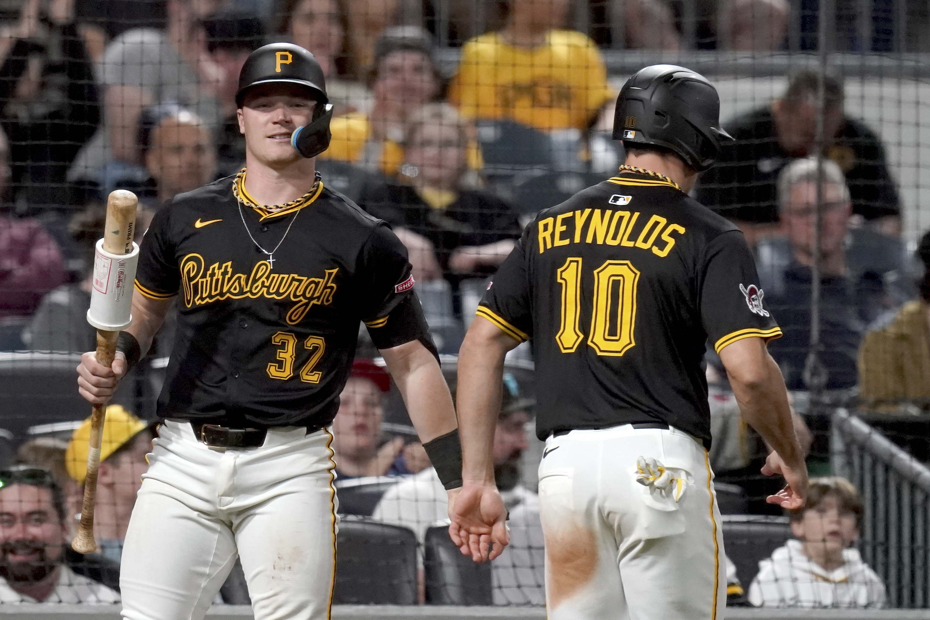 Pittsburgh Pirates' Bryan Reynolds (10) is greeted by Henry Davis (32) after scoring during the eighth inning of a baseball game against the Washington Nationals, Monday, April 14, 2025, in Pittsburgh.  - AP Photo/Matt Freed