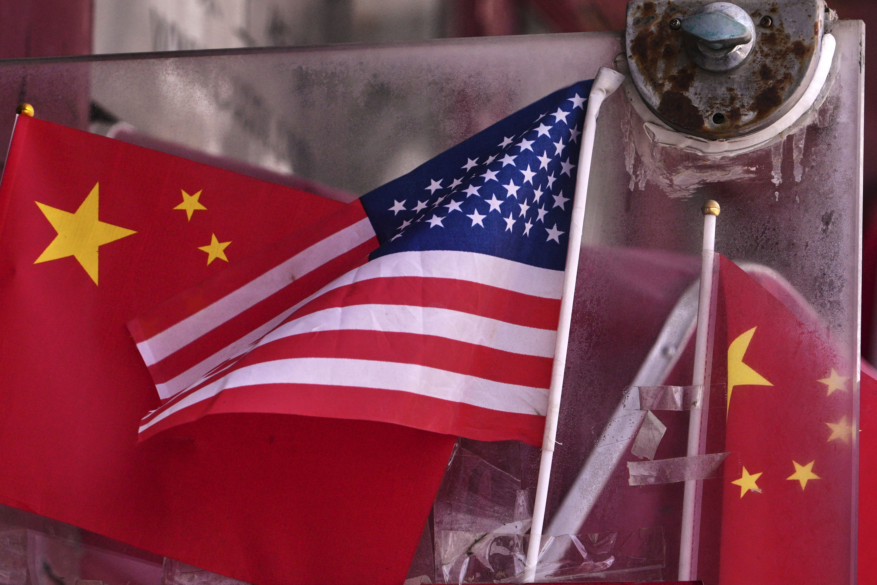 China and U.S. national flags are seen on display on an entrance door of a souvenir shop in Beijing on April 3, 2025.