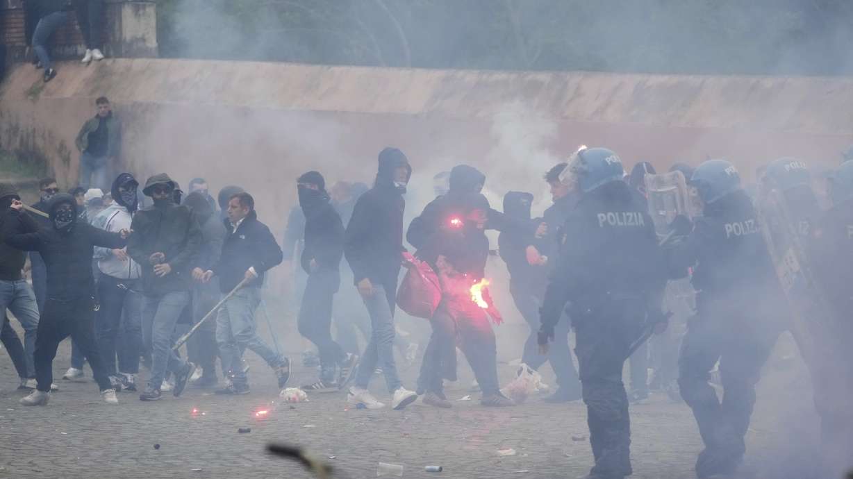 Lazio fans clash with Italian Policemen in riot gears outside the olympic stadium prior to the start of the Italian soccer match between Lazio and Roma in Rome, Sunday, April 13, 2025.