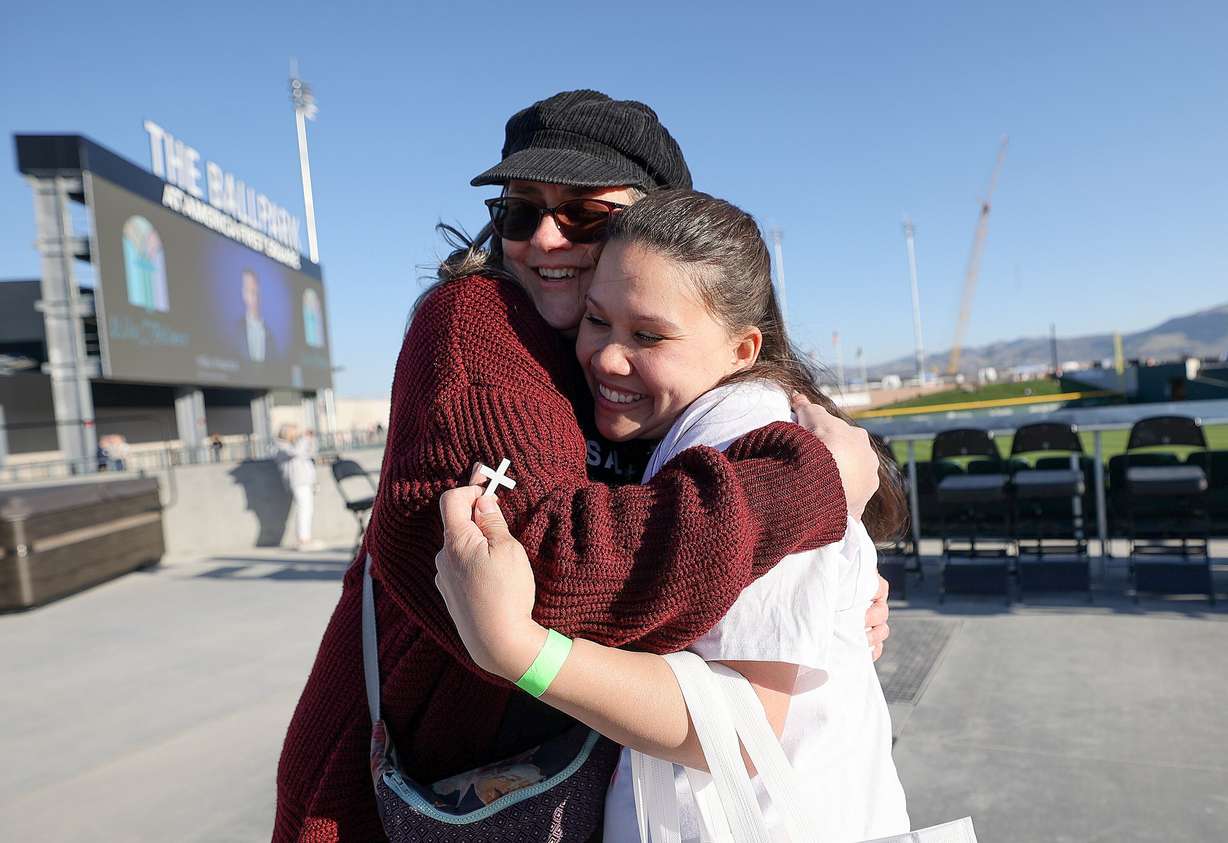 Jessie Blevins and Cortney Denison hug at the Why I Believe Interfaith Easter Celebration at the Ballpark at America First Square in South Jordan on Monday.