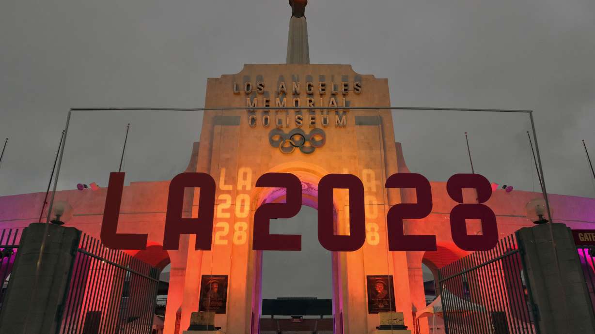 FILE - An LA 2028 sign is seen in front of the Olympic cauldron at the Los Angeles Memorial Coliseum, Wednesday, Sept. 13, 2017.