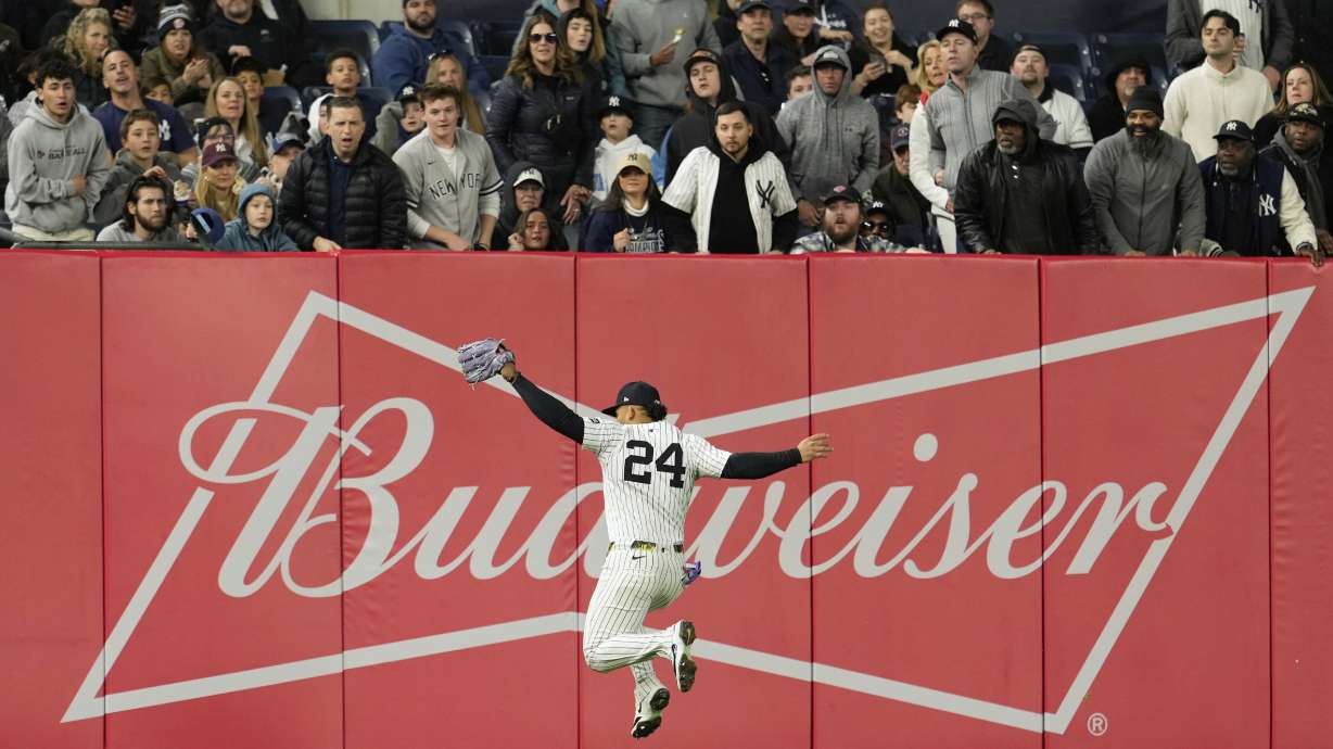 New York Yankees outfielder Jasson Domínguez makes a leaping catch during the fourth inning of a baseball game against the Kansas City Royals Monday, April 14, 2025, in New York.