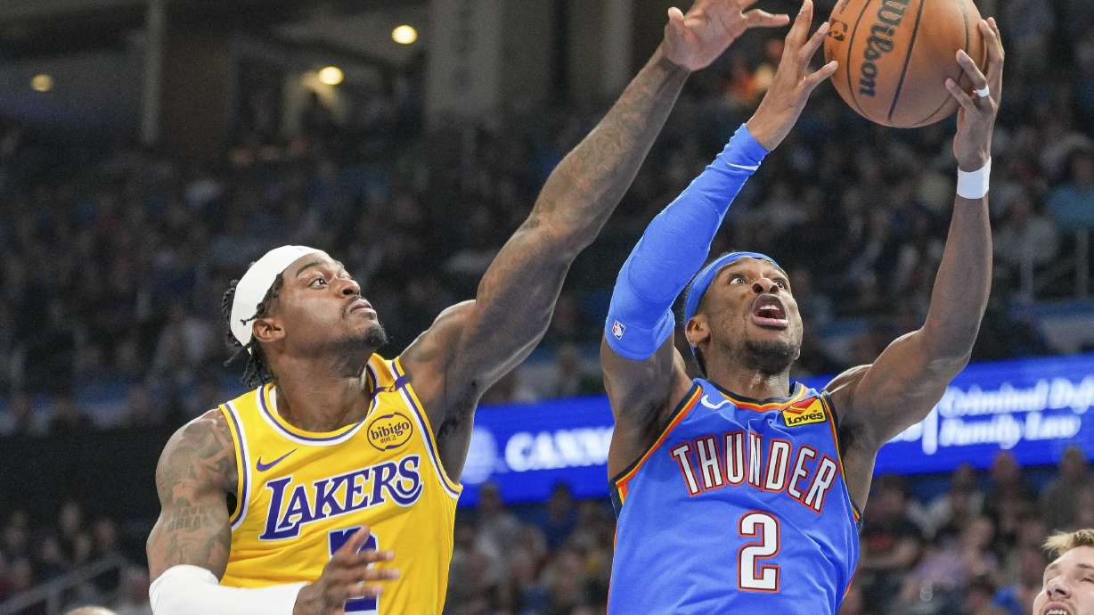 Oklahoma City Thunder guard Shai Gilgeous-Alexander, right, shoots near Los Angeles Lakers forward Jarred Vanderbilt, left, during the second half of an NBA basketball game, Tuesday, April 8, 2025, in Oklahoma City.