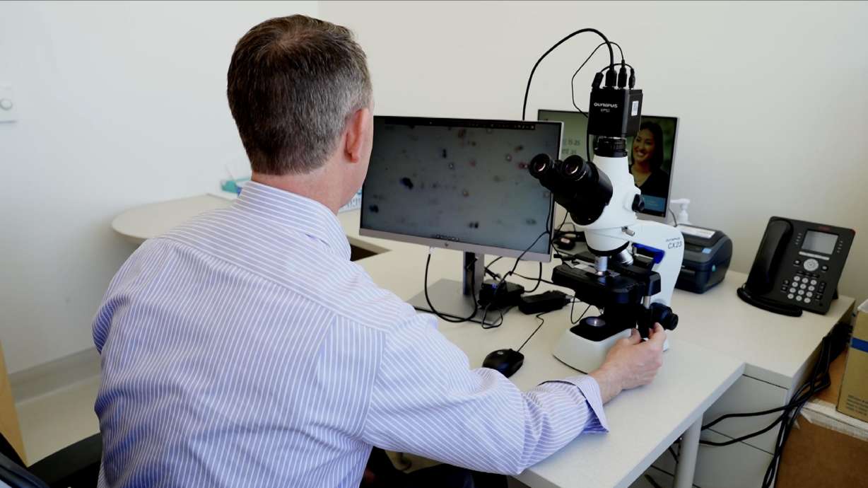 Dr. Scott Taylor looks at a microscope showing pollen in the air. Riverton Hospital recently began reporting the data after installing a pollen-counting station.
