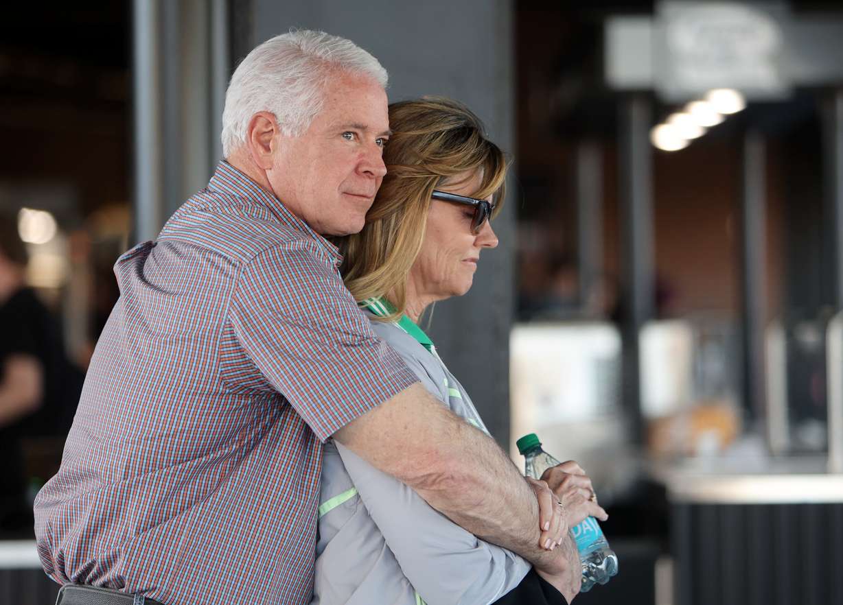 Wayne Wilkinson hugs Michele Wilkinson during a prayer at the Why I Believe Interfaith Easter Celebration at the Ballpark at America First Square in South Jordan on Monday.