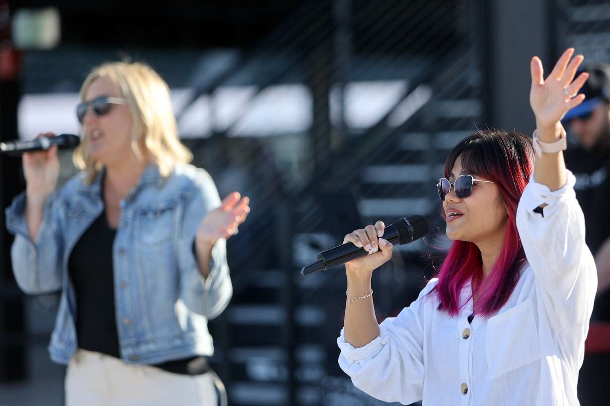 Faith King sings with the Salt and Light Church band at the Why I Believe Interfaith Easter Celebration at the Ballpark at America First Square in South Jordan on Monday.