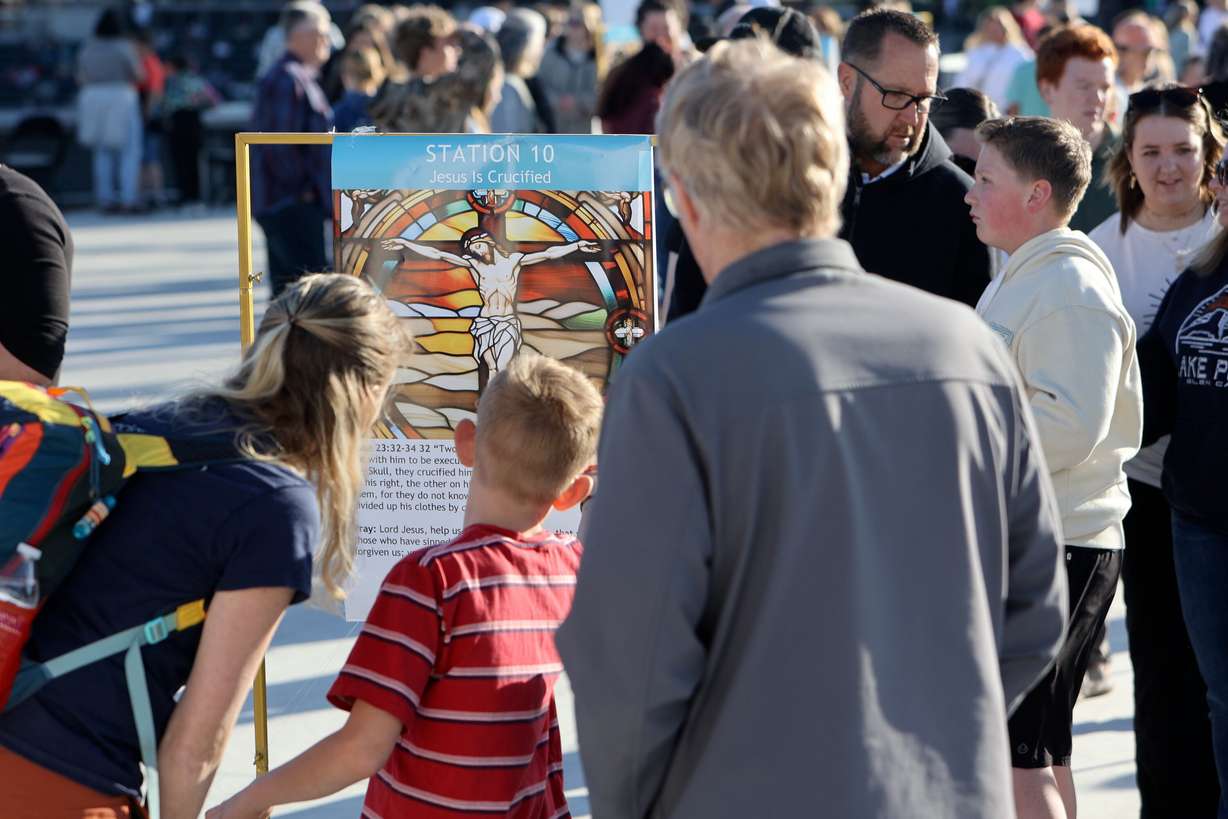 People look at the Stations of the Cross at the Why I Believe Interfaith Easter Celebration at the Ballpark at America First Square in South Jordan on Monday.