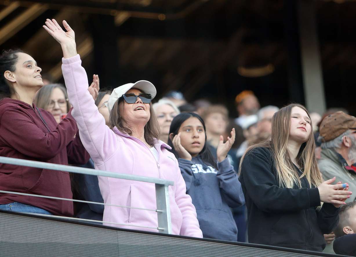 People dance at the Why I Believe Interfaith Easter Celebration at the Ballpark at America First Square in South Jordan on Monday.
