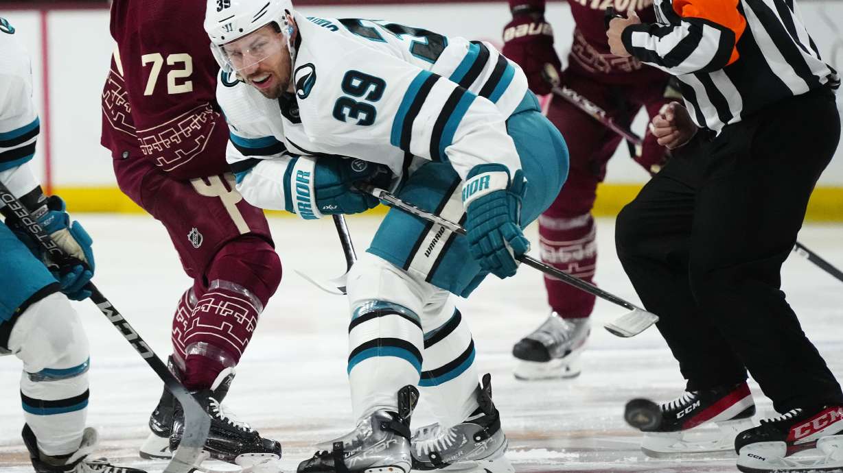 FILE - San Jose Sharks center Logan Couture (39) wins a faceoff against the Arizona Coyotes during the first period of an NHL hockey game Saturday, April 1, 2023, in Tempe, Ariz.
