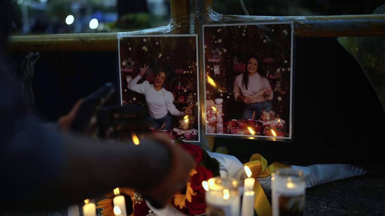 A person lights a candle at a makeshift memorial outside the Jet Set nightclub in Santo Domingo, Dominican Republic, Friday. The first lawsuit against the owners of the nightclub whose roof collapsed and killed 231 was filed Tuesday.