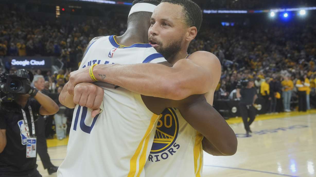 Golden State Warriors forward Jimmy Butler III, left, celebrates with guard Stephen Curry after an NBA play-in tournament basketball game against the Memphis Grizzlies in San Francisco, Tuesday, April 15, 2025.