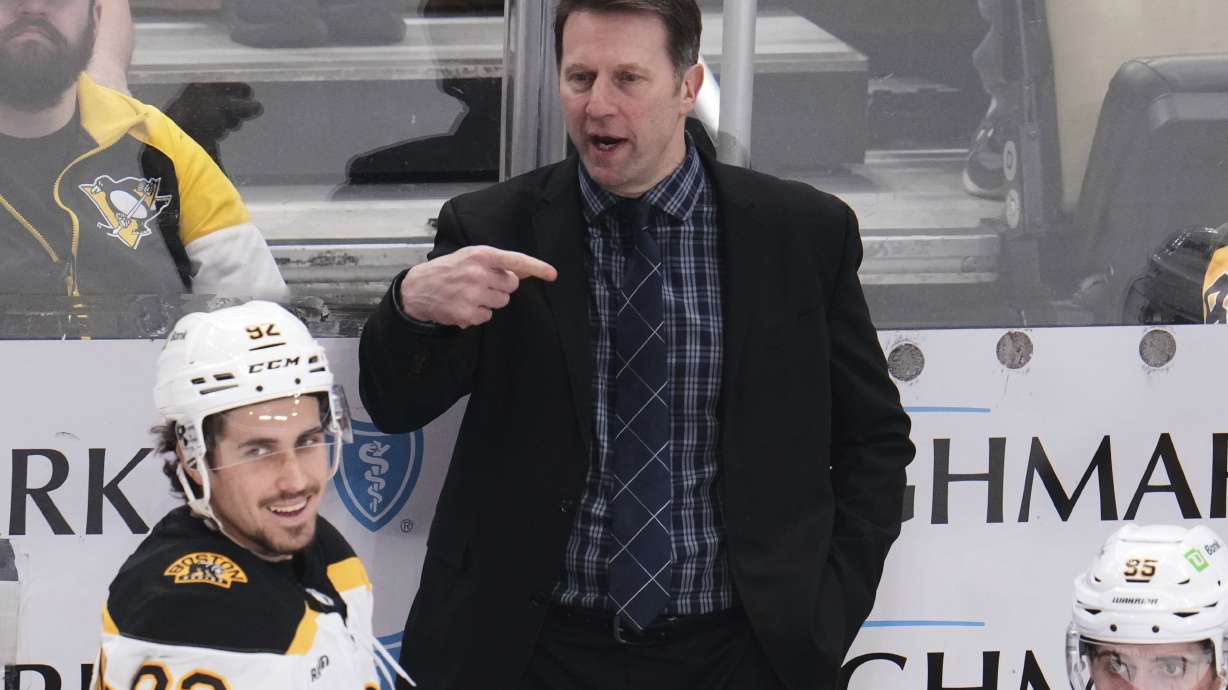 Boston Bruins interim head coach Joe Sacco gives instructions from behind his bench during the third period of an NHL hockey game against the Pittsburgh Penguins in Pittsburgh, Sunday, April 13, 2025.