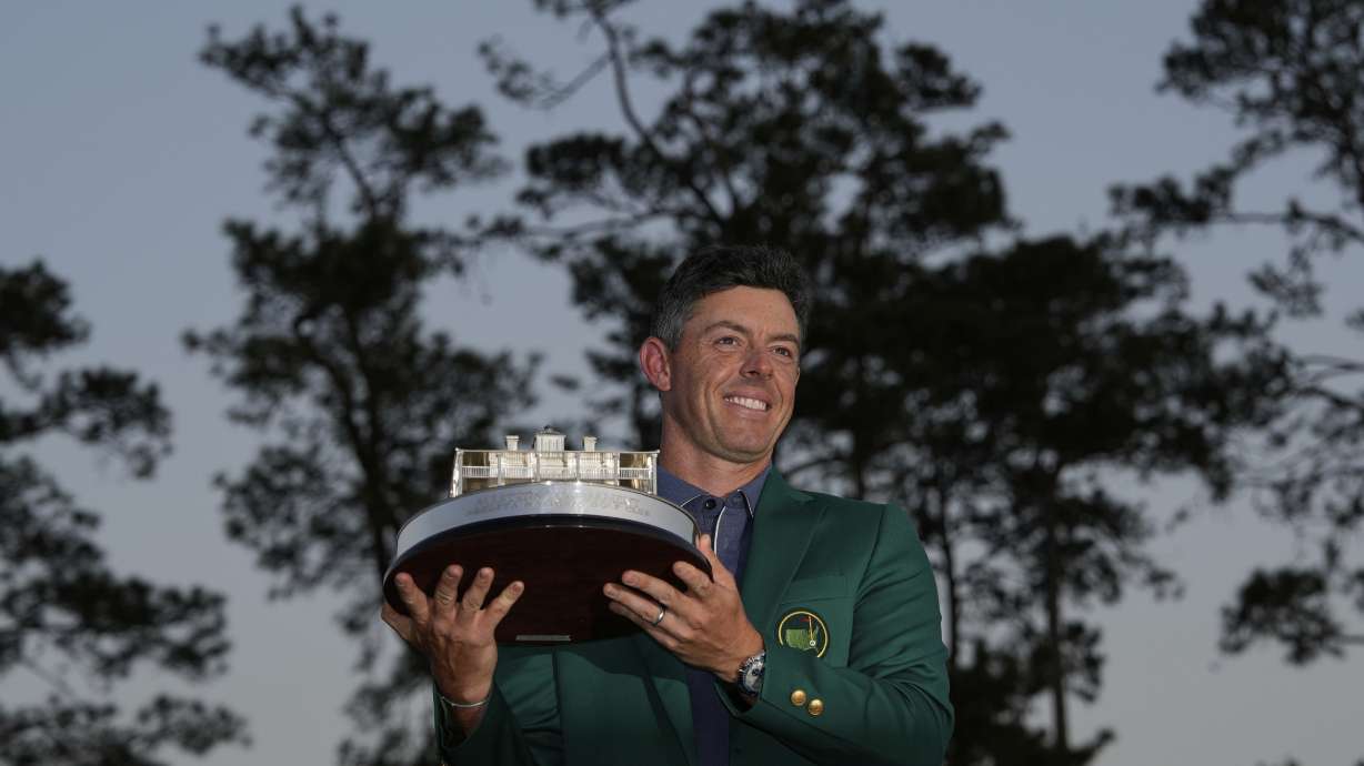 Winner Rory McIlroy, of Northern Ireland, holds the trophy at the Masters golf tournament, Sunday, April 13, 2025, in Augusta, Ga.