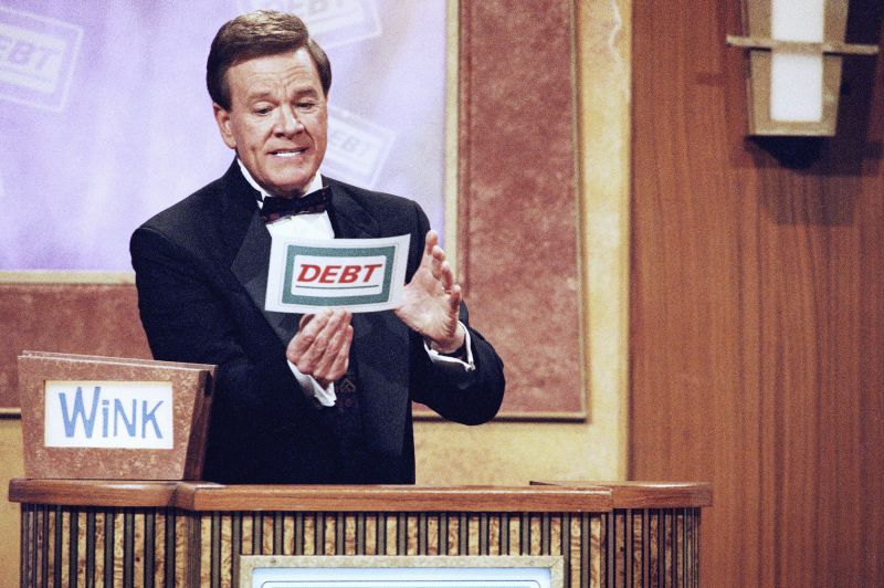 Host Wink Martindale looks at a card during game show, May 22, 1997.