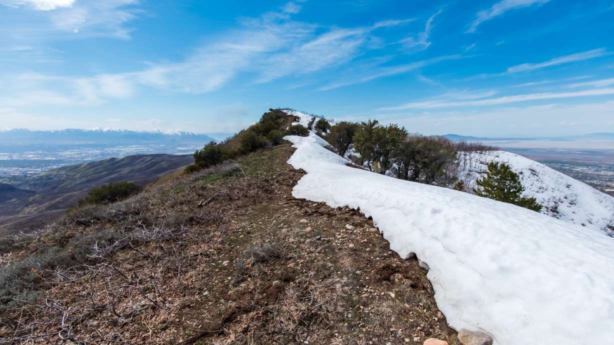 Partial snowmelt is seen atop City Creek Canyon in Salt Lake City on April 12. A report published Wednesday said warmer and drier conditions in April lowered spring runoff projections.