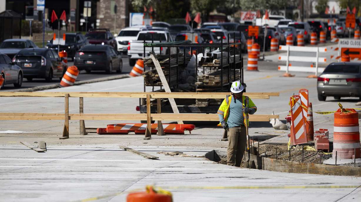 A construction worker works on a project to widen 1800 North in Sunset on Tuesday. The Utah Department of Transportation has announced 152 new construction projects worth $1.68 billion, with another 145 projects already in progress.