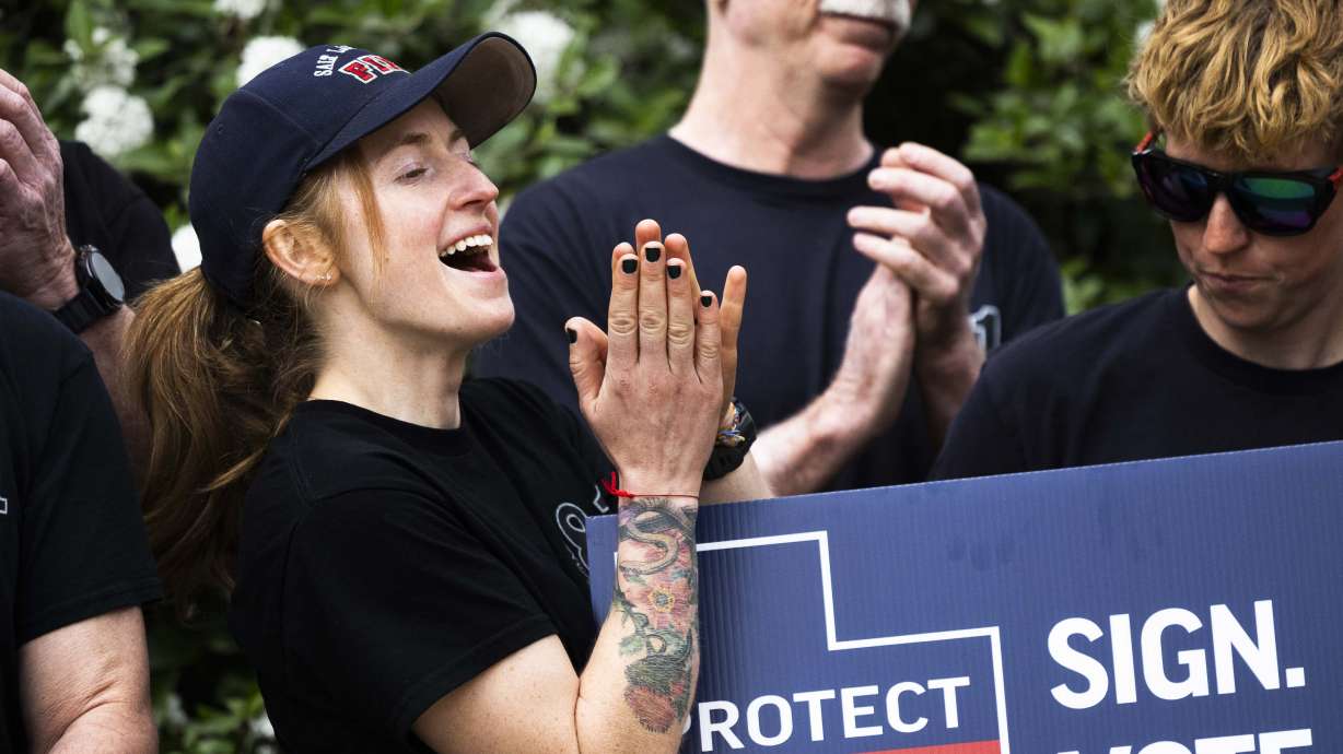 Firefighter Addie Miner claps and cheers following the submission of signatures to the Salt Lake County Clerk's Office supporting a referendum on HB267 on April 16. The referendum appears to have met the threshold for ballot access.