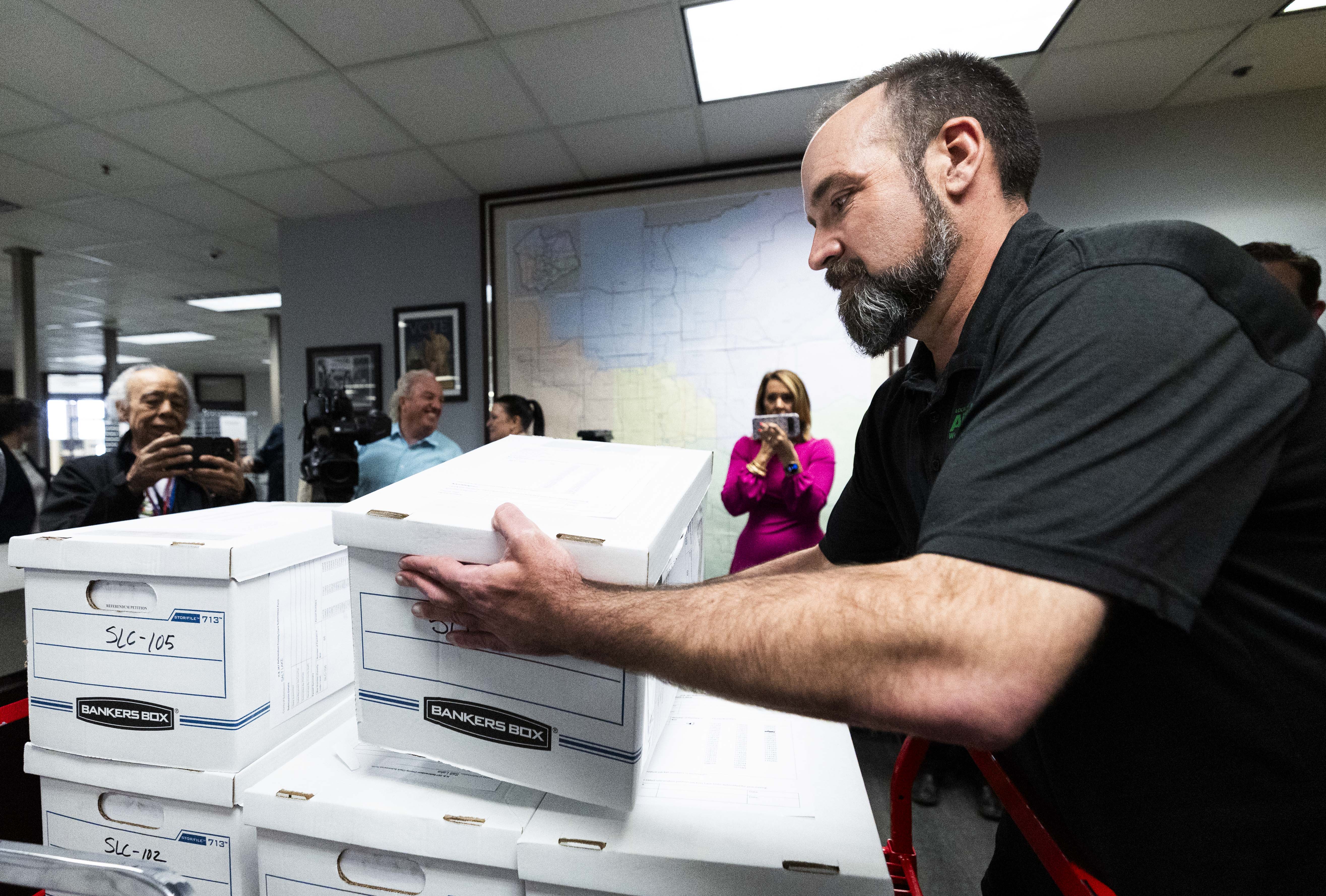 Will Kocher, an executive board member of the American Federation of State, County and Municipal Employees, brings the last box of signatures to be submitted to the Salt Lake County Clerk's office supporting a referendum on HB267 on Wednesday.