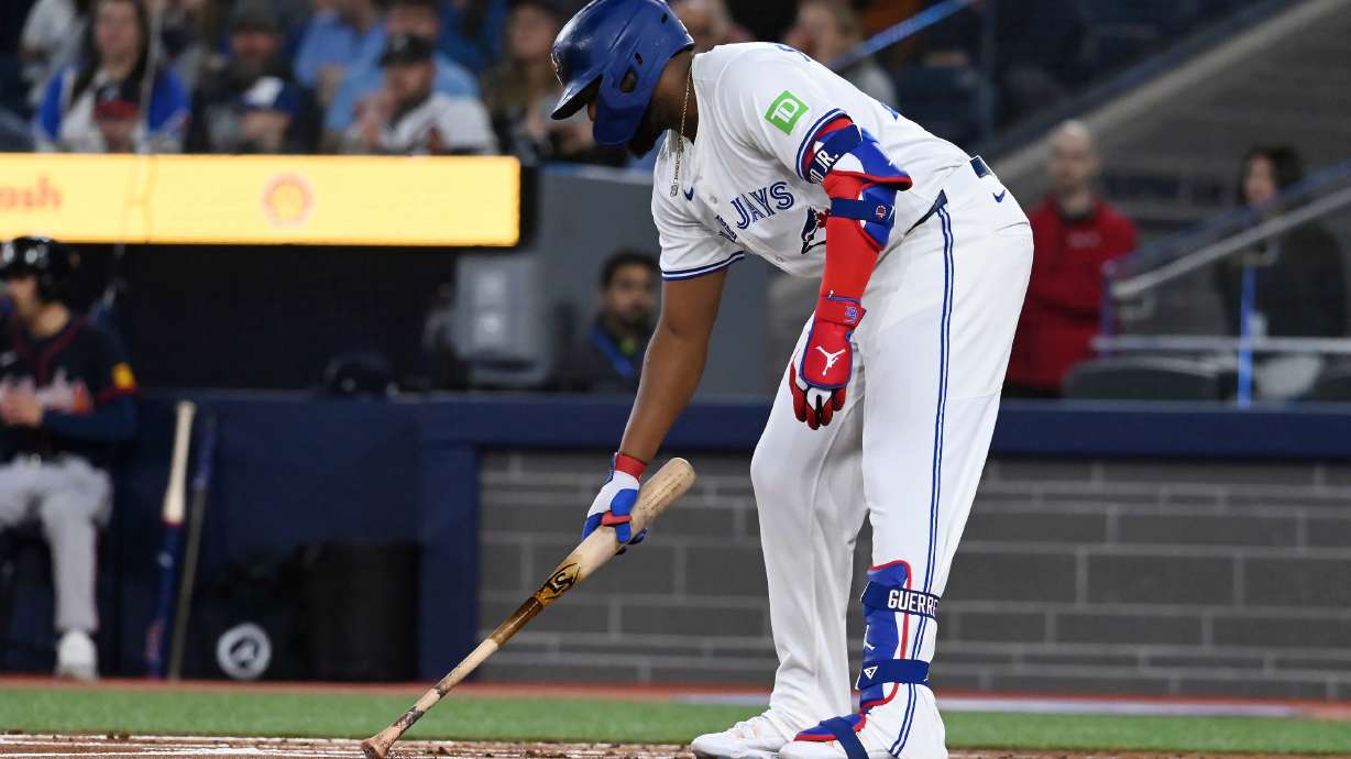 Toronto Blue Jays first baseman Vladimir Guerrero Jr (27) writes in the dirt before an at bat against the Atlanta Braves in the first inning of an interleague baseball game in Toronto, Wednesday, April 16, 2025.
