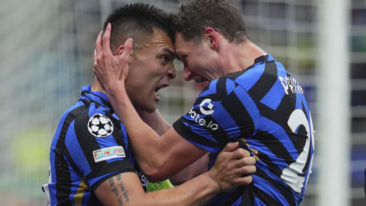 Inter Milan's Lautaro Martinez celebrates after scoring with teammate Benjamin Pavard, right, during the Champions League quarter final soccer match between Inter Milan and Bayern Munich at San Siro Stadium in Milan, North Italy, Wednesday April 16, 2025.