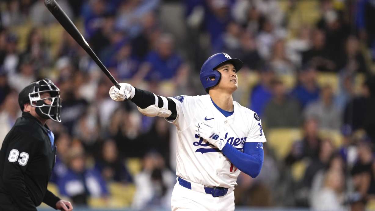 Los Angeles Dodgers' Shohei Ohtani watches his ball go out for a solo home run during the first inning of a baseball game against the Colorado Rockies Wednesday, April 16, 2025, in Los Angeles.