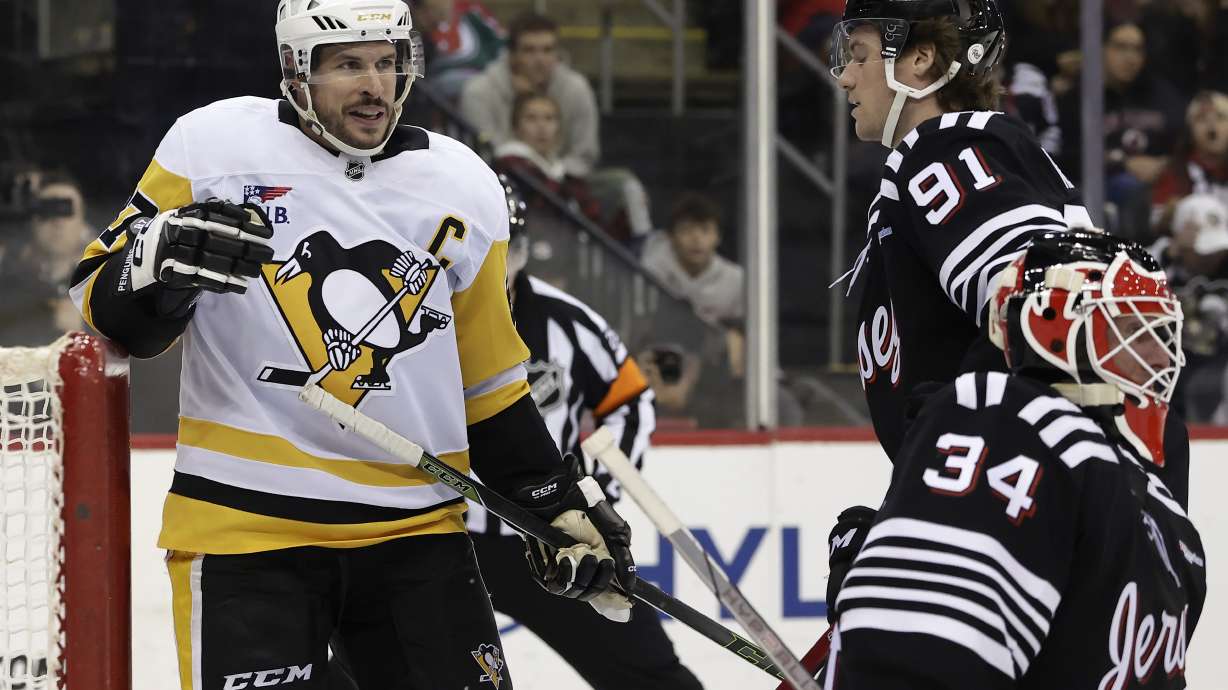 Pittsburgh Penguins center Sidney Crosby (87) reacts after scoring a goal past New Jersey Devils goaltender Jake Allen in the third period of an NHL hockey game Friday, April 11, 2025, in Newark, N.J.
