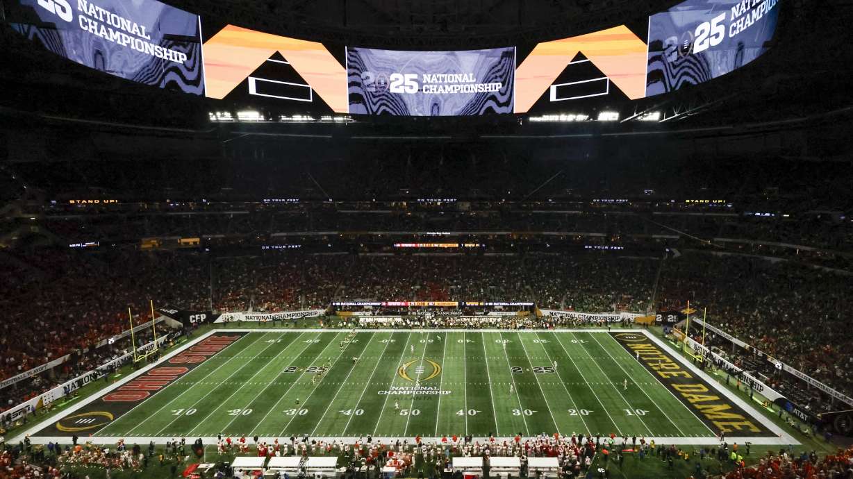 FILE - Fans watch during second half of the College Football Playoff national championship game between Ohio State and Notre Dame, Jan. 20, 2025, in Atlanta.