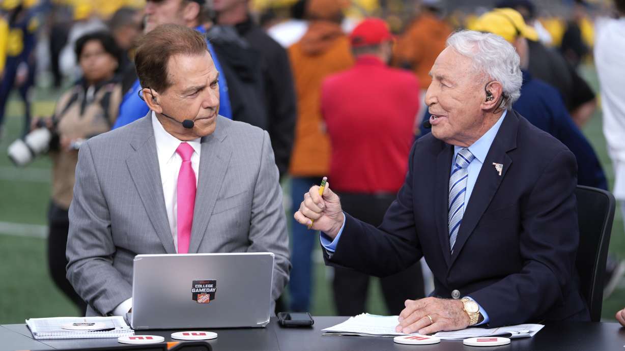 FILE - Nick Saban, left, and Lee Corso talk on the set of ESPN College Gameday on the sideline before an NCAA college football game between Michigan and Texas in Ann Arbor, Mich., Sept. 7, 2024.