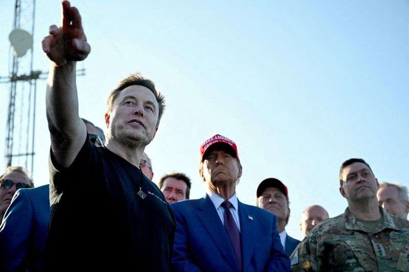 Elon Musk speaks with U.S. President-elect Donald Trump and guests at a viewing of the launch of the sixth test flight of the SpaceX Starship, in Brownsville, Texas, Nov. 19, 2024.