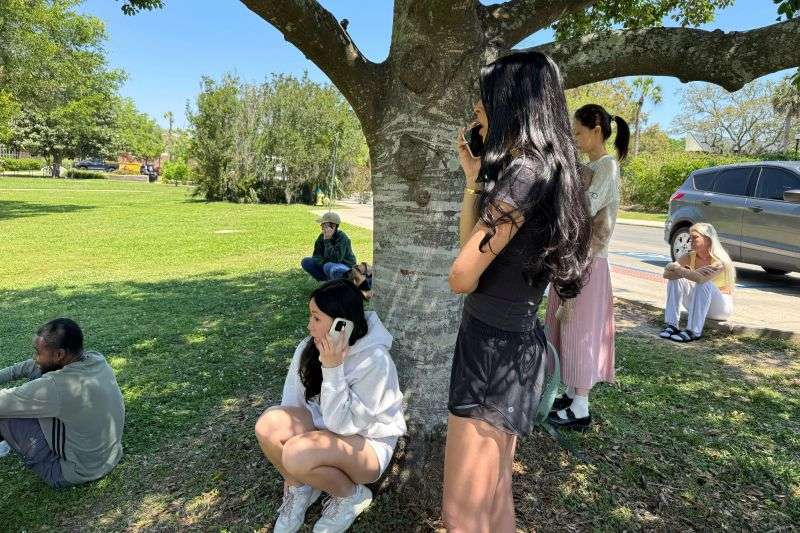 Florida State University students wait for news amid an active shooter incident at the school’s campus in Tallahassee, Fla., Thursday.