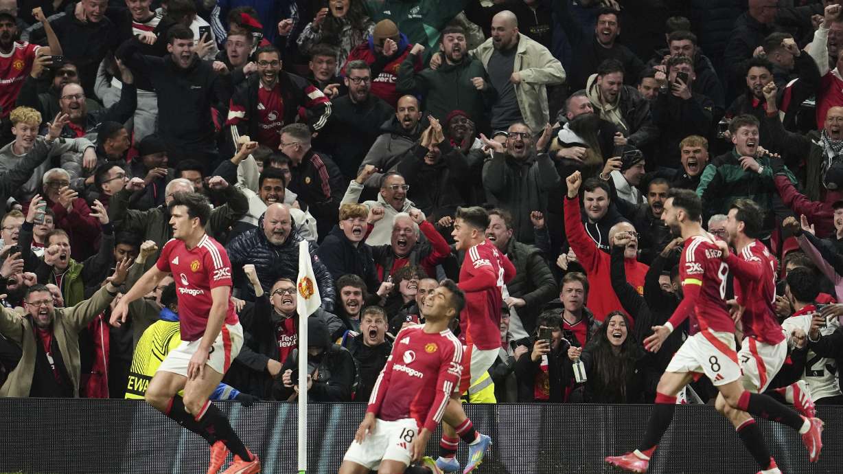 Manchester United's Harry Maguire, left, celebrates with team mates after his side's fifth goal during the Europa League quarter final second leg soccer match between Manchester United and Olympique Lyon in Manchester, Britain, Thursday, April 17, 2025.