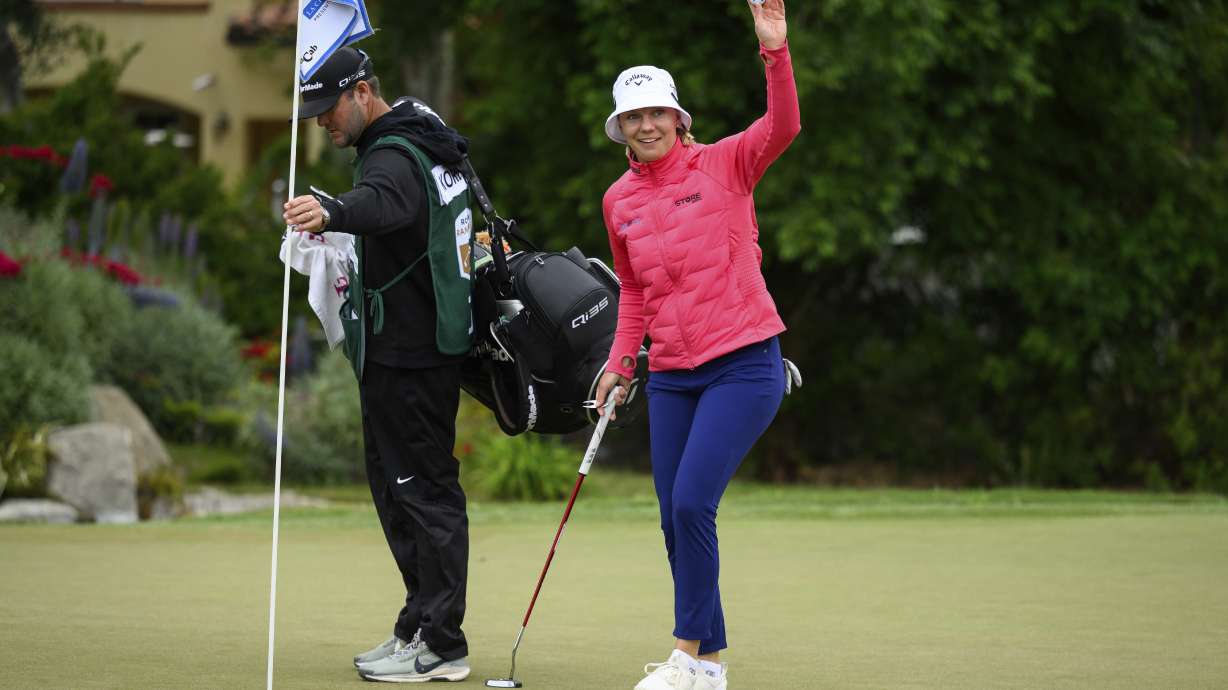 Madelene Sagstrom, right, gestures to the crowd after making a hole-in-one on the ninth hole during the first round of the LPGA's JM Eagle LA Championship golf tournament at El Caballero Country Club, Thursday, April 17, 2025, in Los Angeles.