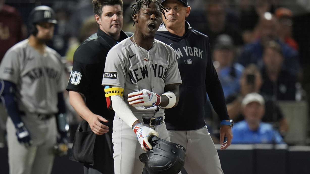 New York Yankees' Jazz Chisholm Jr., center, reacts after getting called out on strikes by home plate umpire John Bacon, left, during the seventh inning of a baseball game against the Tampa Bay Rays Thursday, April 17, 2025, in Tampa, Fla.
