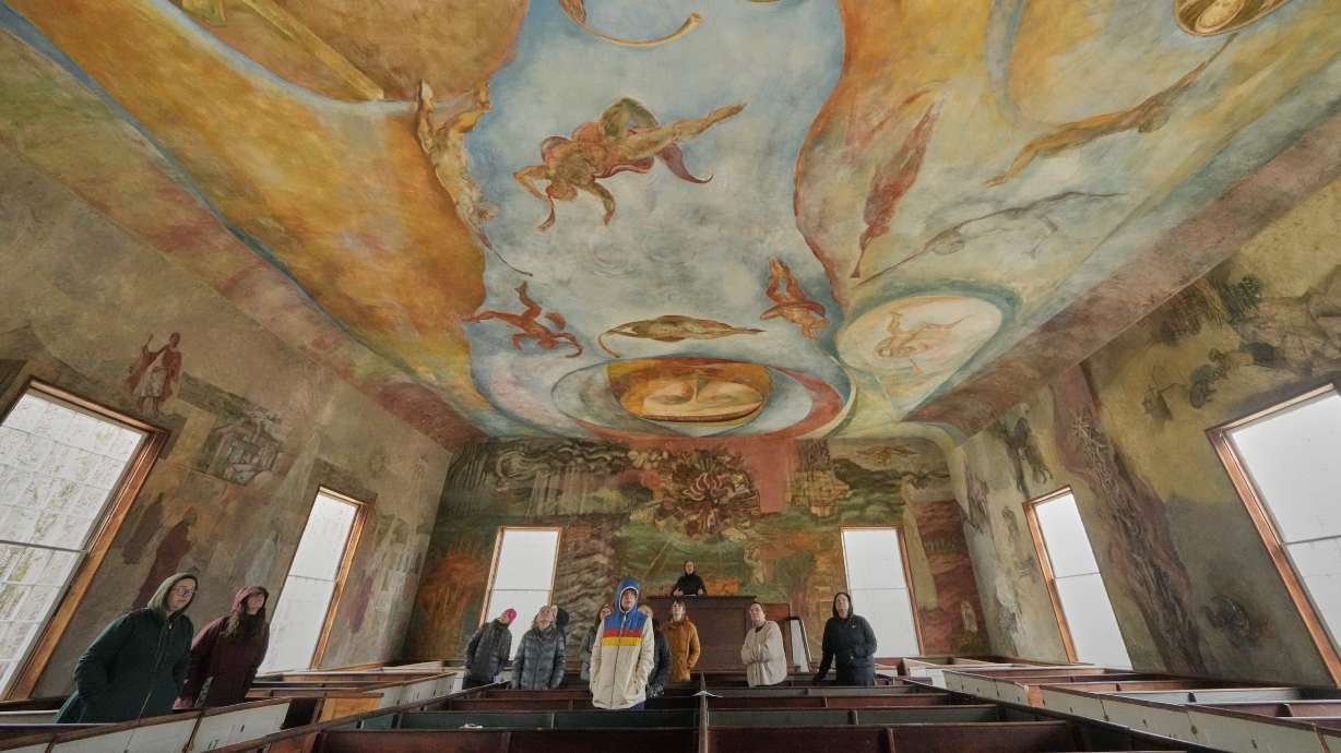 Visitors view the frescoes at the South Solon Meeting House, April 6, in Solon, Maine.