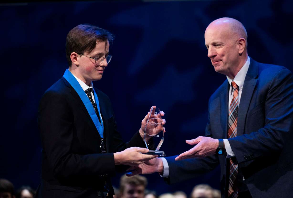 Senior adviser of education with the governor's office, Rich Nye, right, presents Luca DalCanto of Skyline High School with the Excellence in Education Governor’s Award at the 2025 Sterling Scholar Ceremony at the Conference Center Little Theater in Salt Lake City on Thursday.