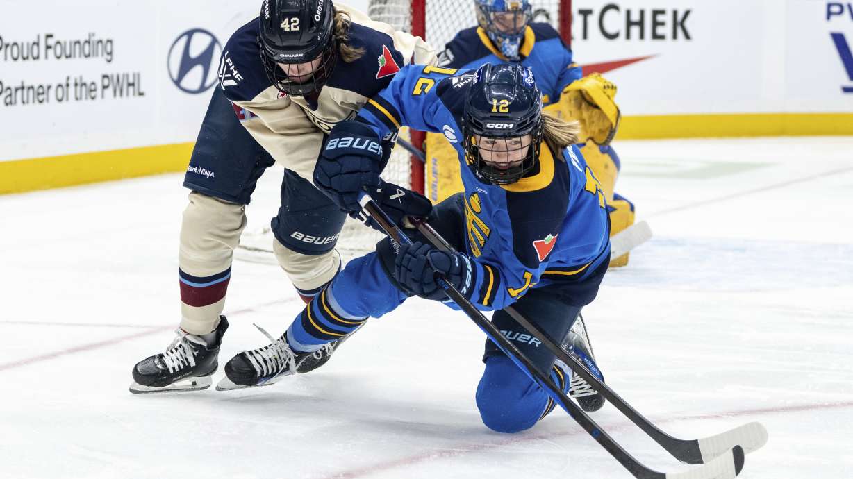FILE - Montreal Victoire's Claire Dalton (42) and Toronto Sceptres' Allie Munroe (12) vie for the puck during first period PWHL hockey action in Vancouver, on Wednesday, January 8, 2025.