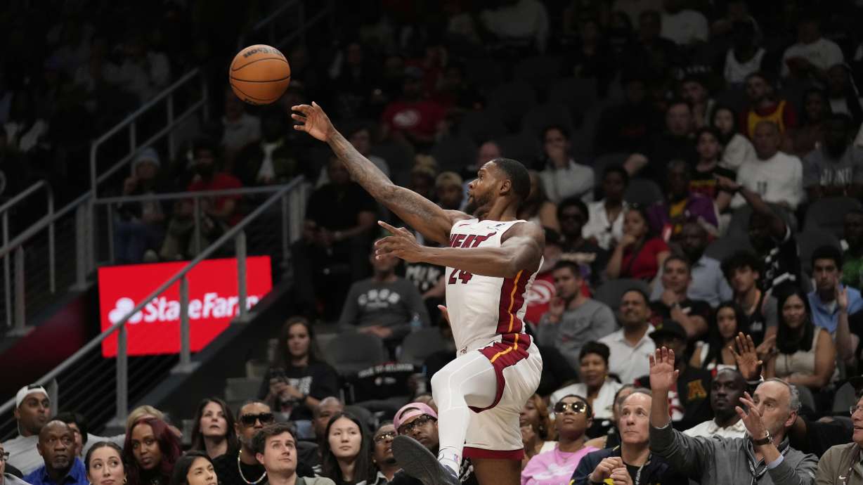 Miami Heat forward Haywood Highsmith (24) keeps the ball in bounds in the first half of an NBA play-in tournament basketball game against the Atlanta Hawks, Friday, April 18, 2025, in Atlanta.
