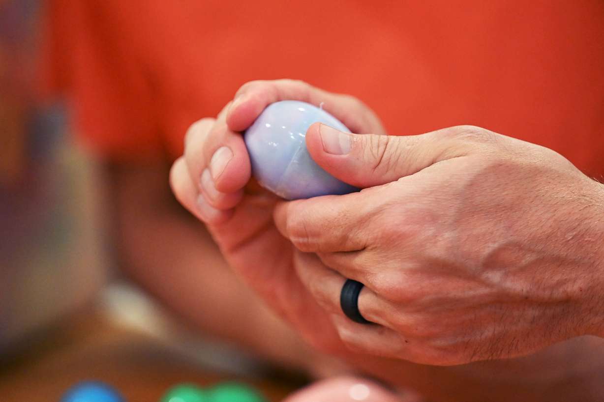 JR Curtis closes an egg as the Curtis family takes part in some Easter celebrations on Wednesday.