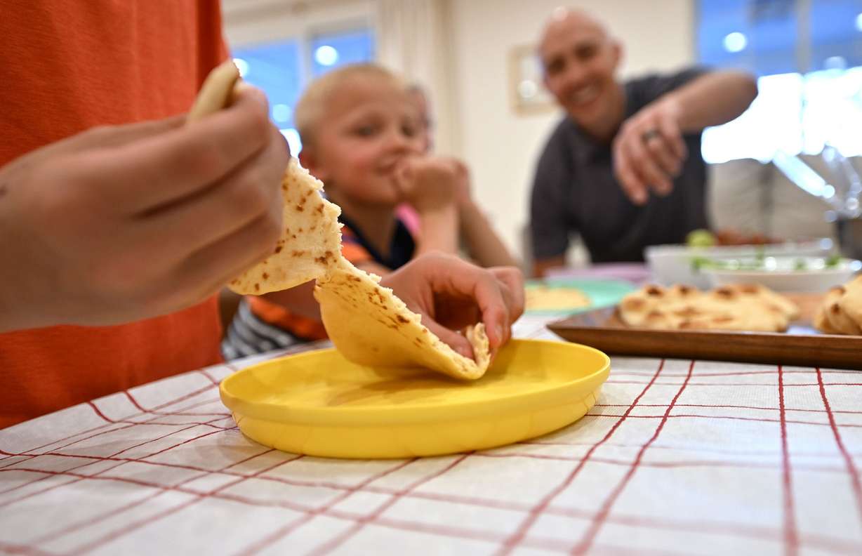 John pulls his bread apart as the Curtis family takes part in some Easter celebrations on Wednesday.