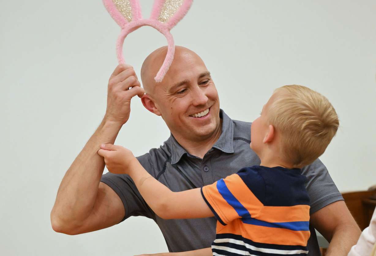 JR Curtis plays with son Jay as the family does some Easter preparations on Wednesday.