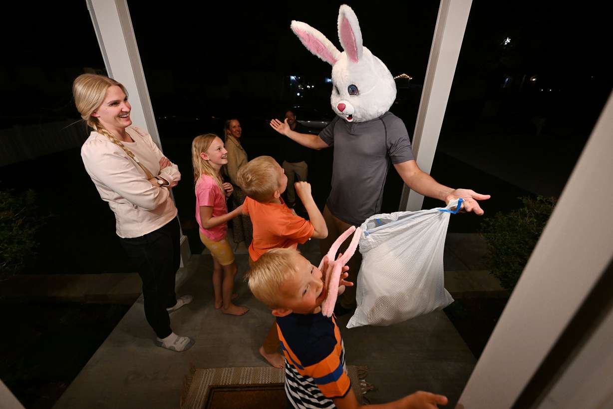 JR Curtis shows a giant Easter Bunny head that is part of a costume that he will wear for the neighborhood hunt for his family on Wednesday.