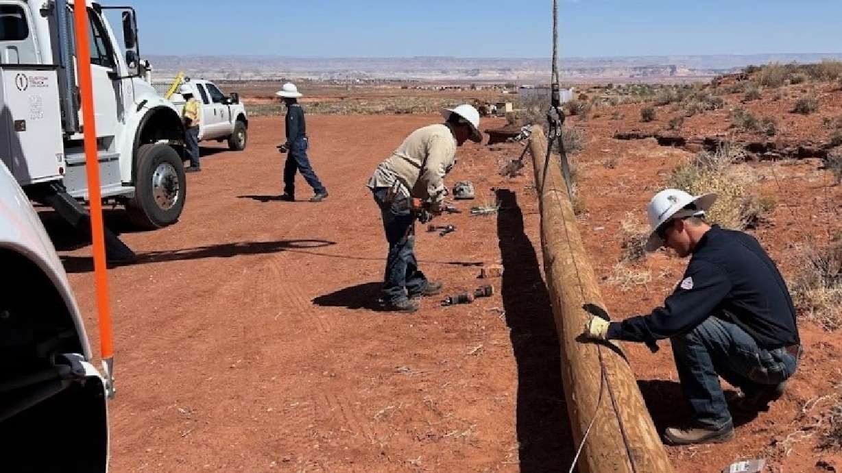 A crew from Provo Power helps with a Navajo Nation electrification initiative on Monday.
