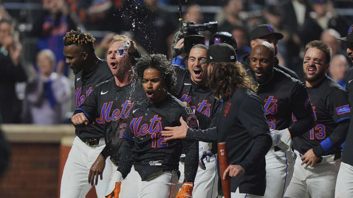 New York Mets' Francisco Lindor (12) celebrates with teammates after hitting a walk-off home run during the ninth inning of a baseball game against the St. Louis Cardinals Friday, April 18, 2025, in New York.
